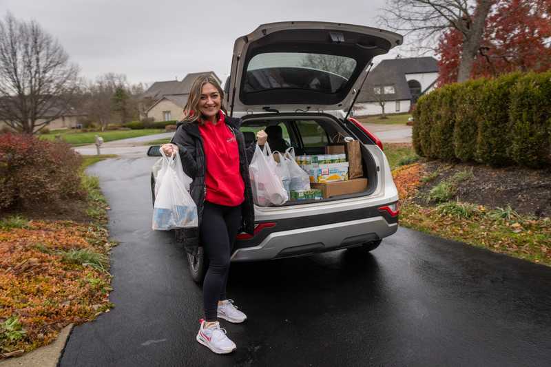 Joscelyn of Roof Revivers picking up donations for the 2025 food drive with her team.