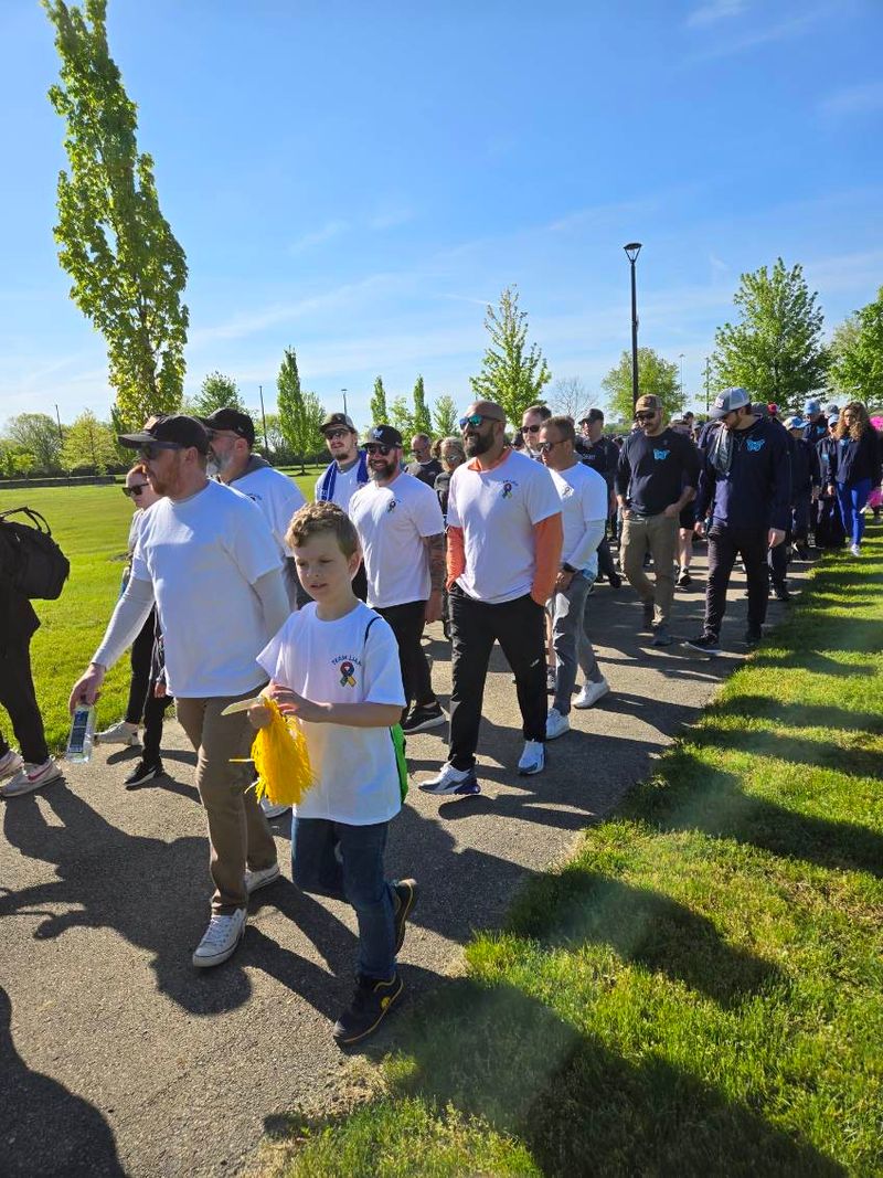 The Roof Revivers team begins their walk at the 2025 Autism Speaks event.